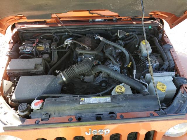 1J4HA5H15BL555144 - 2011 JEEP WRANGLER U SAHARA ORANGE photo 12