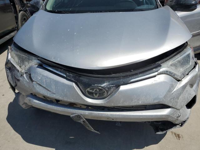 2T3ZFREV7JW472451 - 2018 TOYOTA RAV4 LE SILVER photo 12