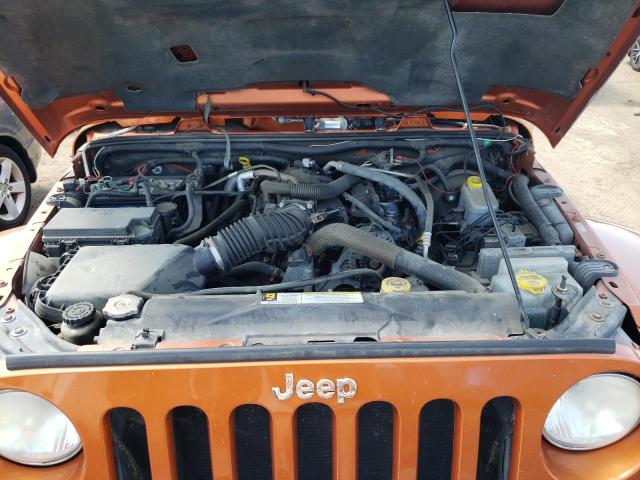 1J4AA5D11AL192024 - 2010 JEEP WRANGLER SAHARA ORANGE photo 11