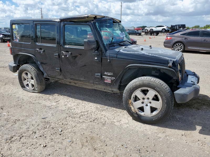 1J4HA5H17BL542623 - 2011 JEEP WRANGLER U SAHARA შავი ფოტო 4