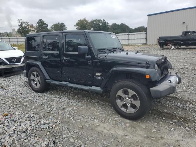 1C4BJWEG2EL142631 - 2014 JEEP WRANGLER U SAHARA BLACK photo 4